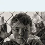 boy looking through fence accidental childhood exposure to porn - Cole's story